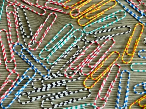 Multi-colored paper clips scattered Stock Photos