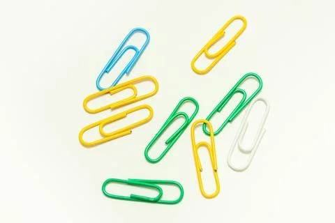 Multi-colored paper clips on a white background Stock Photos