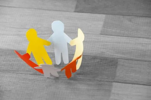 Multi colored paper cut outs forming circle on wooden table Stock Illustration
