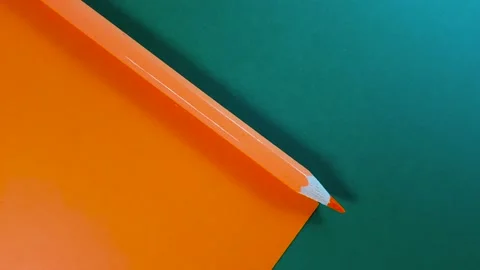 Multi-colored paper moves towards each other. Pencils with colored paper in stop Stock Footage 144076693