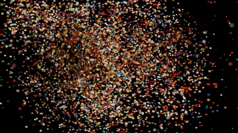 Multi colored particles fly colorful sprinkles bouncing black background Stock Footage 106733116