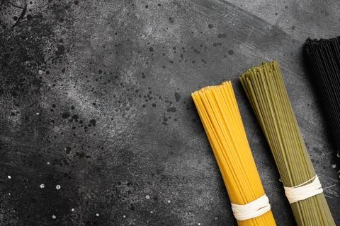Multi colored pasta, on black dark stone table background, top view flat lay, Foto stock
