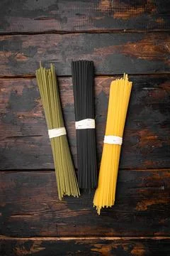Multi colored pasta, on old dark wooden table background, top view flat lay,  Stock Photos