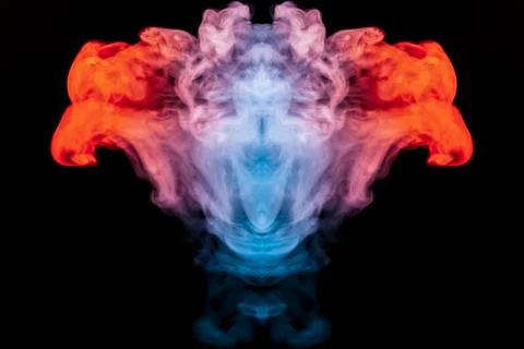 A multi-colored pattern of blue and red smoke of a mystical shape in the form Stock Photos