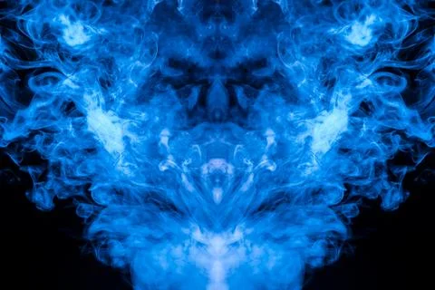 A multi-colored pattern of blue smoke of a mystical shape in the form of a fa 스톡 사진
