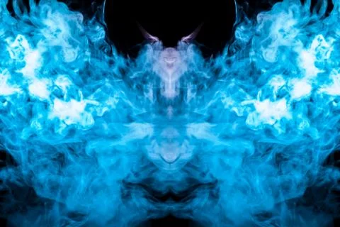 A multi-colored pattern of blue smoke of a mystical shape in the form of a fa Stock Photos