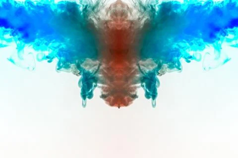 A multi-colored pattern of red and blue smoke of a mystical shape in the form Fotos de archivo
