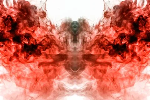 A multi-colored pattern of red smoke of a mystical shape in the form of a fac Stock Photos