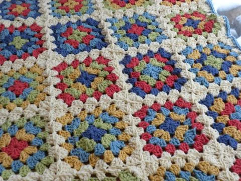 Multi-colored patterns of crocheted rug Stock Photos
