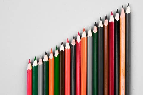 Multi-colored pencils on a gray background Foto stock