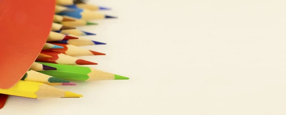 Multi-colored pencils in a red box. Stock Photos
