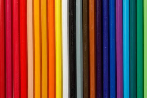 Multi-colored pencils in a row Stock Photos