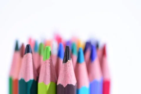 Multi-colored pencils sharpened on a white background, depth of field. Backgr Stock Photos