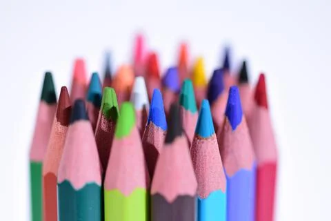 Multi-colored pencils sharpened on a white background, depth of field. Backgr Stock Photos