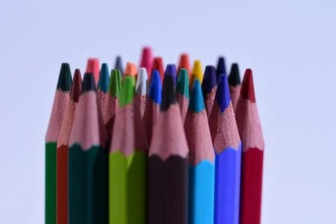 Multi-colored pencils sharpened on a white background, depth of field. Backgr Stock Photos