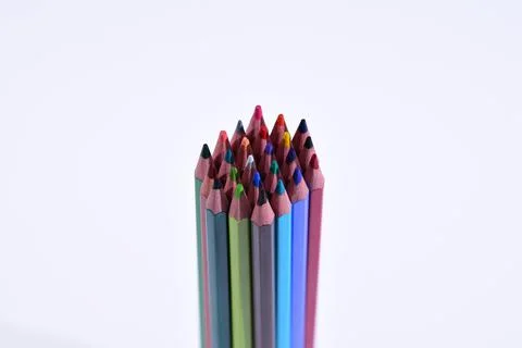 Multi-colored pencils sharpened on a white background, depth of field. Backgr Stock Photos