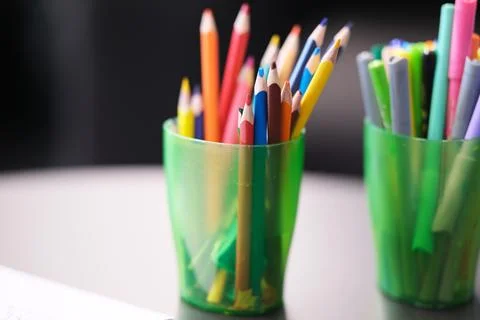 Multi-colored pencils stand on the table Stock Photos