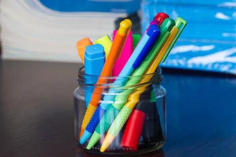 Multi-colored pens and markers in a stand on the background of Stack Stock Photos