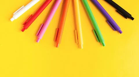 Multi colored pens on a yellow background. Banner. Stationery. Copy space. Stock-Fotos