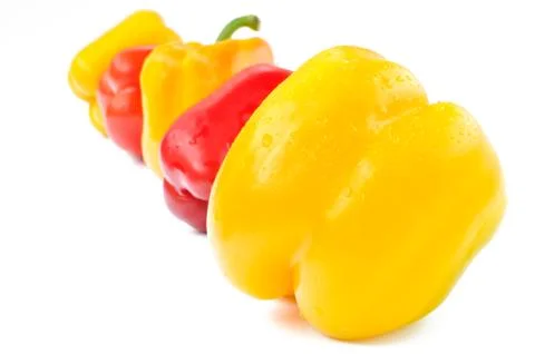 Multi-colored peppers on a white background Stock Photos