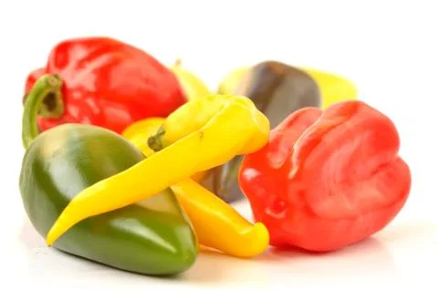 Multi-colored peppers on a white background Stock Photos