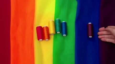 Multi-colored pieces of fabric and a threads on the table preparation for the Stock Footage 156049631