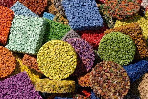 Multi-colored pieces of flooring made from painted rubber crumbs, products .. Stock Photos