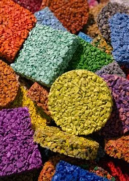 Multi-colored pieces of flooring made from painted rubber crumbs, products .. Stock Photos
