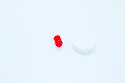 Multi-colored pills are located on a white background Stock Photos