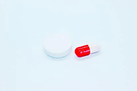 Multi-colored pills are located on a white background Stock Photos