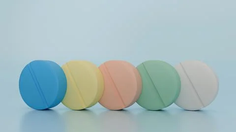 Multi-colored pills stand on a blue background, medicine Stock Photos