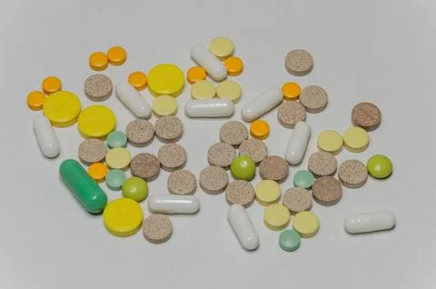 Multi-colored pills on the table Stock Photos