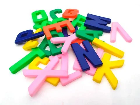 Multi colored plastic alphabet isolated on white background Foto stock