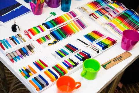 Multi-colored plastic ballpoint pens on white table Stock Photos