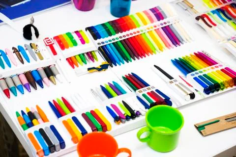 Multi-colored plastic ballpoint pens on white table Stock Photos