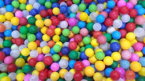 Multi-colored plastic balls. A children's playroom. beautiful toys Stock Photos