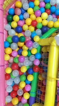 Multi-colored plastic balls. A children's playroom. beautiful toys Stock Photos