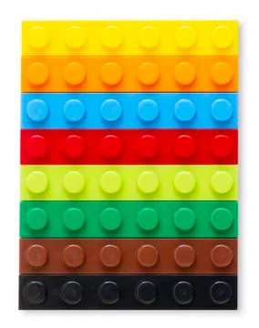 Multi-colored plastic building block on white background Foto stock