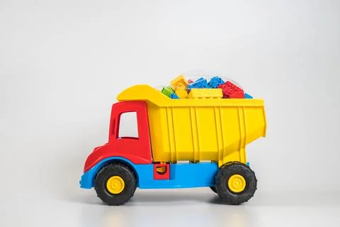 Multi-colored plastic children's toy cars on a white background. 스톡 사진