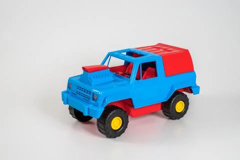 Multi-colored plastic children's toy cars on a white background. 写真素材