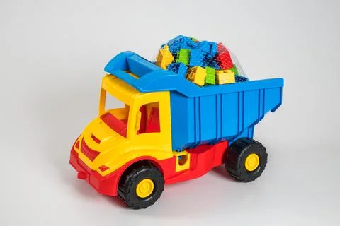 Multi-colored plastic children's toy cars on a white background. 写真素材