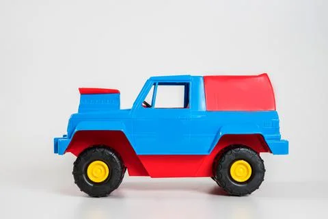Multi-colored plastic children's toy cars on a white background. 写真素材