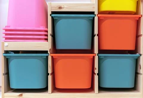 Multi-colored plastic containers for storing children's things. Stock Photos