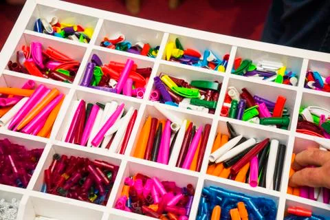 Multi-colored plastic disassembled ballpoint pens in boxes Stock Photos