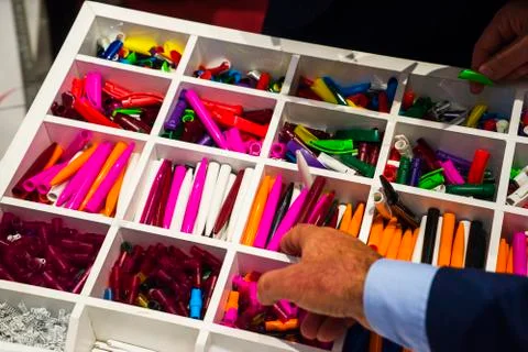 Multi-colored plastic disassembled ballpoint pens in boxes Stock Photos