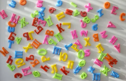 Multi-colored plastic letters of Russian alphabets and numbers Stock Photos
