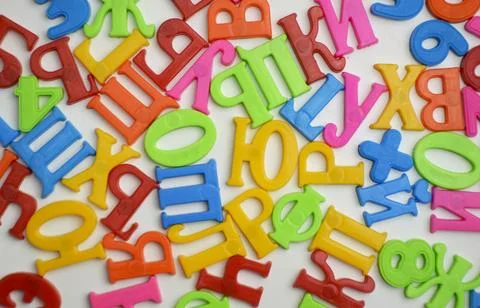 Multi-colored plastic letters of Russian alphabets and numbers Stock Photos