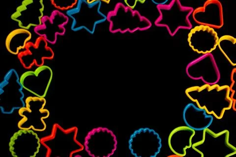 Multi-colored plastic molds of various shapes for the manufacture of cookies  Stock Photos