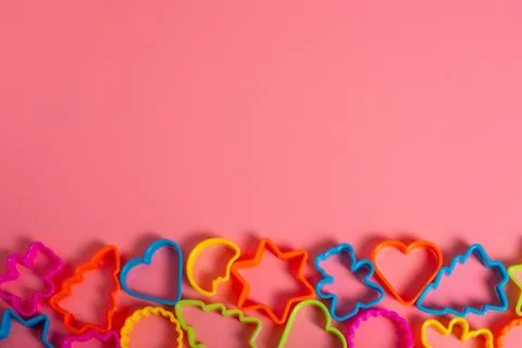 Multi-colored plastic molds of various shapes grouped below for making cookie 写真素材