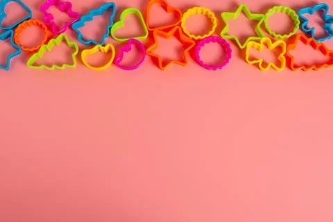 Multi-colored plastic molds of various shapes grouped on top for making cooki Stock Photos